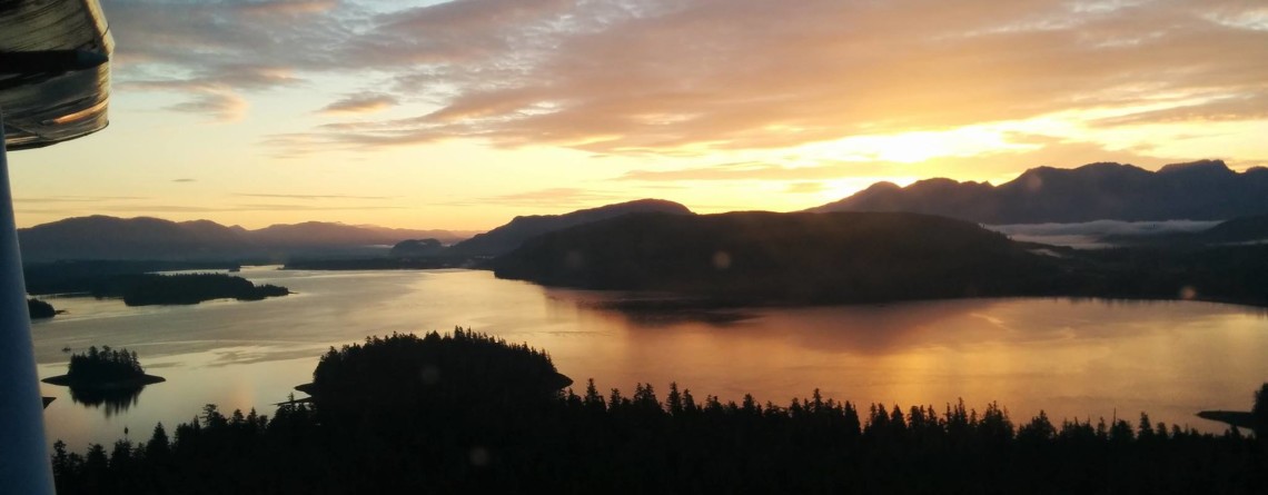 Golden aerial view from a seaplane over island waterways at sunset